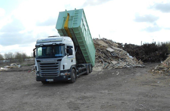 LKW kippt Altholz weg
